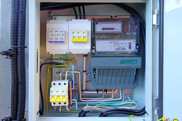 Introductory electrical box with three-phase electricity meter and circuit breakers.