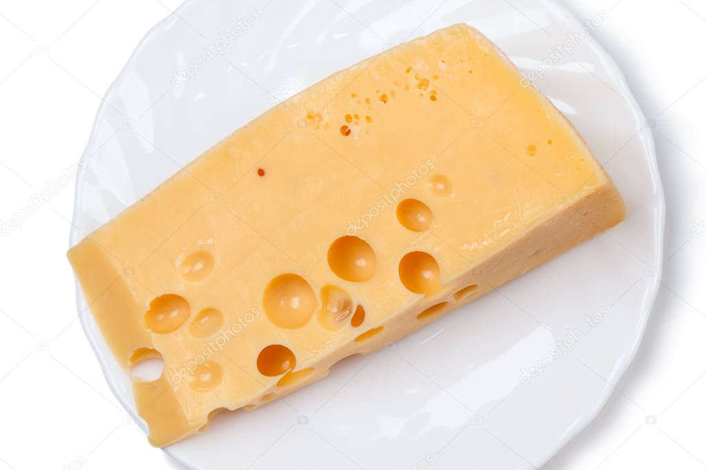Piece of cheese on a white plate. Made from cow's milk, it is aged for at least 4 weeks. 