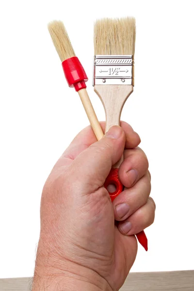 Two brushes in hand — Stock Photo, Image