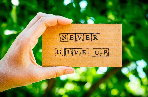 Woman Hand Holding Cardboard Card Words Never Give Made Black — Stock Photo, Image