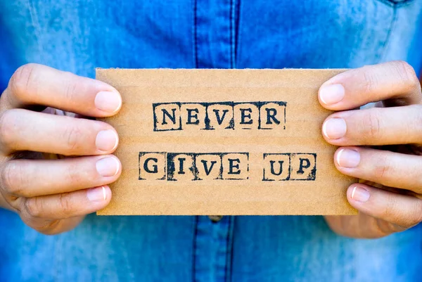 Woman Hand Holding Cardboard Card Words Never Give Made Black — Stock Photo, Image