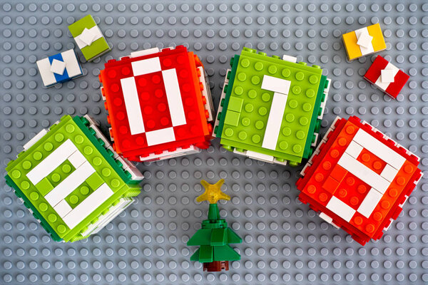 Tambov, Russian Federation - September 02, 2018 Lego New year 2019 concept with Lego cubes, gifts and Christmas tree on gray baseplate background.