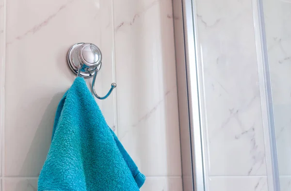 Голубое полотенце висит на вешалке в ванной комнате . — стоковое фото