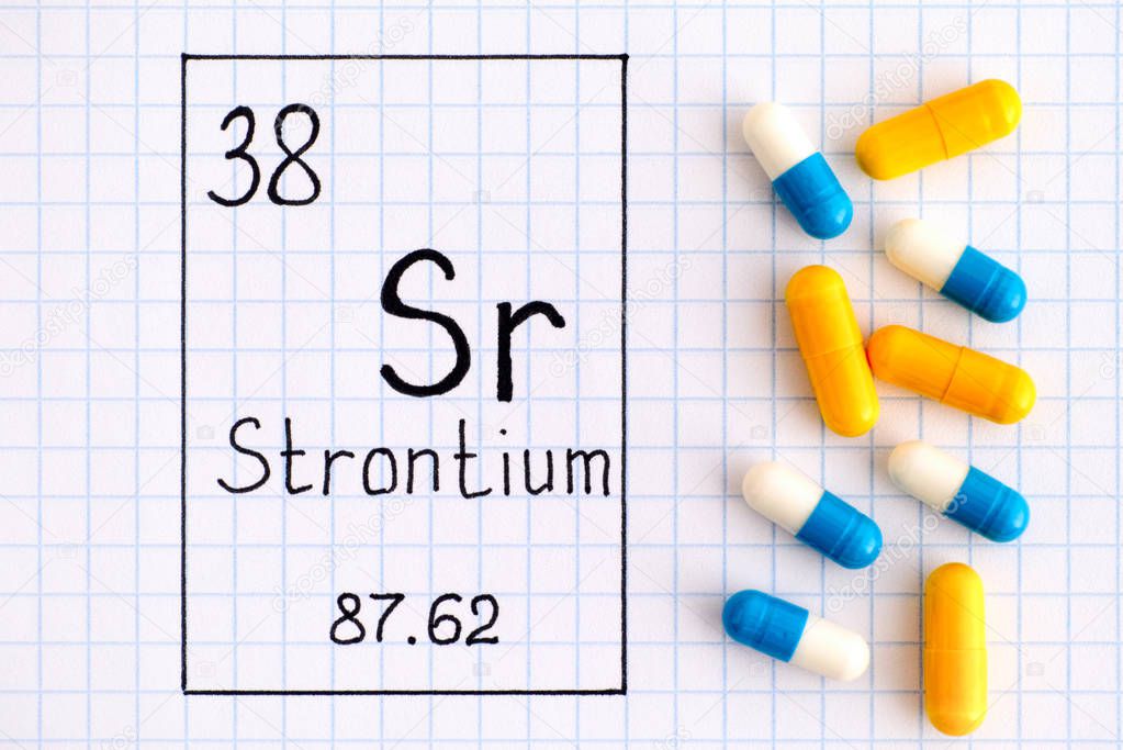 Handwriting chemical element Strontium Sr with some pills.