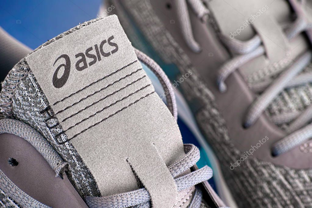 Tambov, Russian Federation - April 16, 2019 Close-up of new gray Asics running shoes. Studio shot.