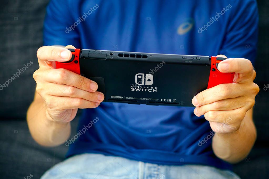 Tambov, Russian Federation - June 22, 2019 Man playing Nintendo Switch video game console.