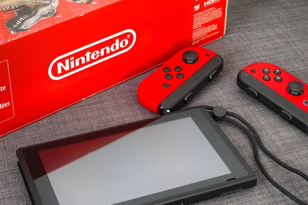 Red box with Nintendo Switch video game console and two Joy-Cons — Stock Photo, Image