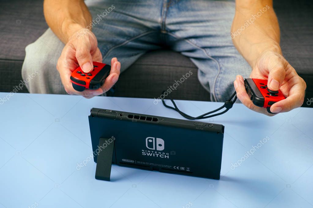 Tambov, Russian Federation - June 22, 2019 Man playing Nintendo Switch video game console.