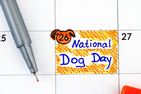 Reminder National Dog Day in calendar with pen.