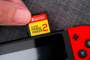 Super Mario Maker 2 video oyunu cartridg ekleme kişi parmakları