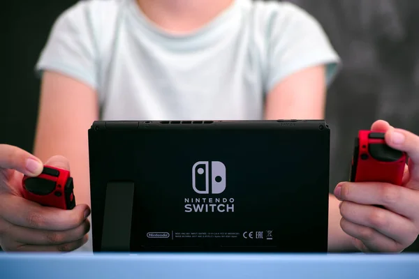 Boy playing Nintendo Switch video game console. — Stock Photo, Image