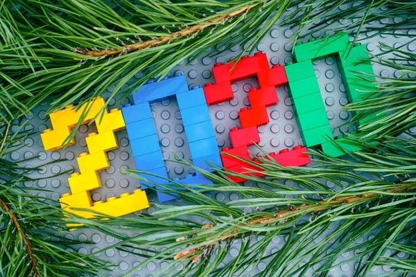 Numbers 2020 made by Lego blocks and pine branches on Lego gray — Stock Photo, Image