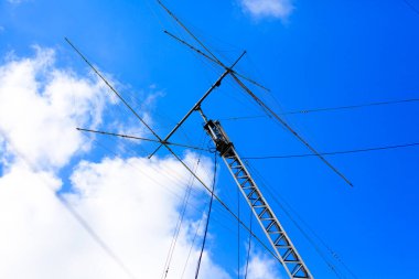 Ham radio antenna against cloudy sky. clipart