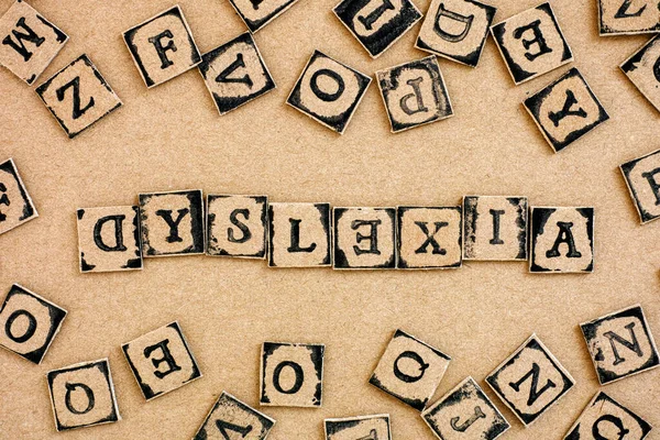 Word Dyslexia Spelled Out Cardboard Letters Made Black Alphabet Stamps — Stock Photo, Image