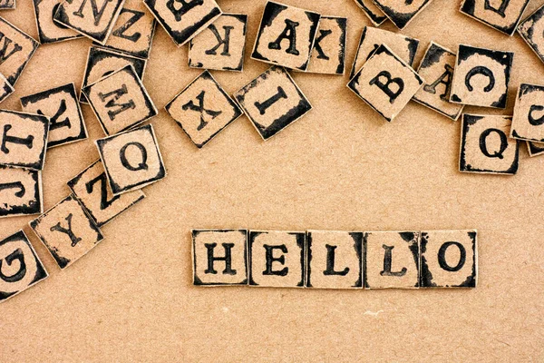 Word Hello Spelled Out Cardboard Letters Made Black Alphabet Stamps — Stock Photo, Image