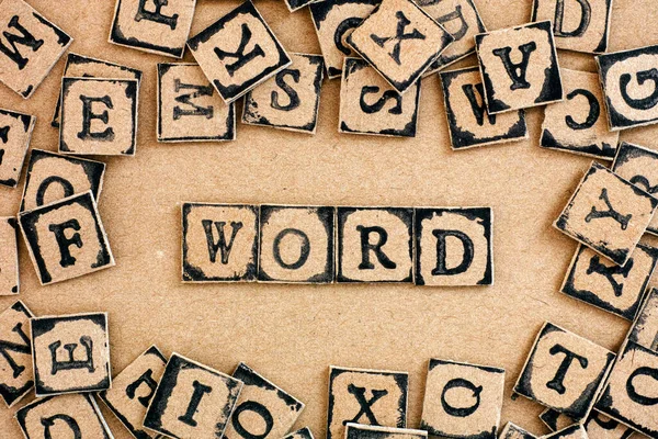 Text Word Spelled Out Cardboard Letters Made Black Alphabet Stamps — Stock Photo, Image