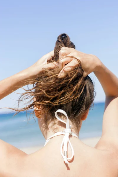Νεαρή Γυναίκα Στην Παραλία Κρατώντας Μαλλιά Απαλή Εστίαση Εικόνα Αρχείου
