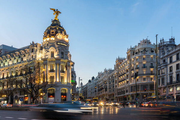 MADRID, SPAIN - JANUARY 23, 2018: Sunset view of Gran Via and Metropolis Building (Edificio Metropolis) in City of Madrid, Spain