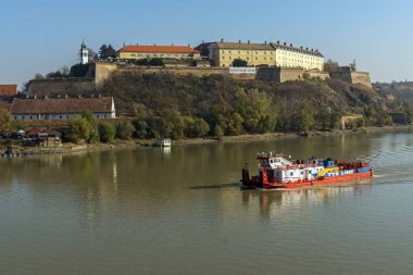 NOVI SAD, VOJVODINA, SERBIA - NOVEMBER 11, 2018: View of Petrovaradin Fortress from the Danube river in the City of Novi Sad, Vojvodina, Serbia clipart