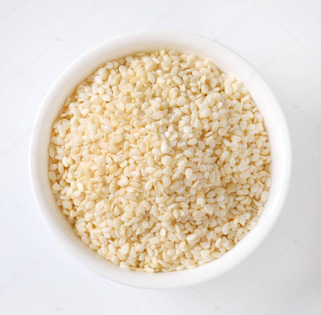 bowl of healthy sesame seeds on white background
