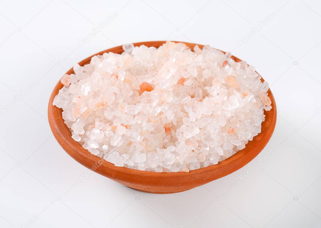 bowl of coarse grained Himalayan salt on white background