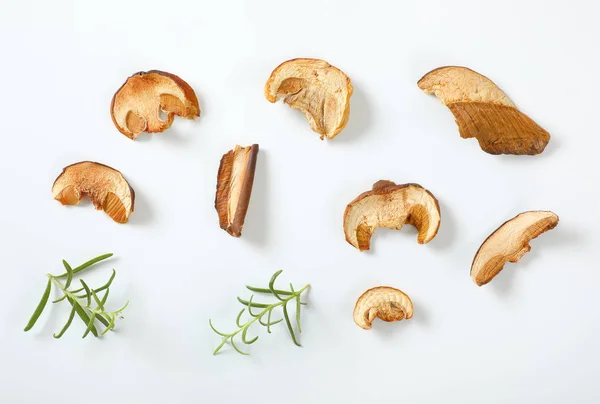 Slices Dried Mushrooms Rosemary White Background — Stock Photo, Image
