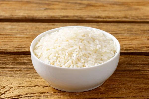 Reis Einer Schüssel Auf Holzgrund — Stockfoto
