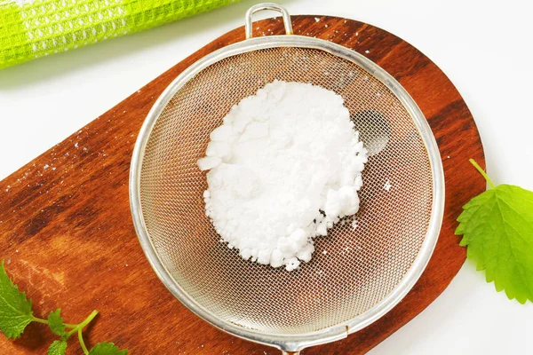 Powdered sugar in a sieve — Stock Photo, Image