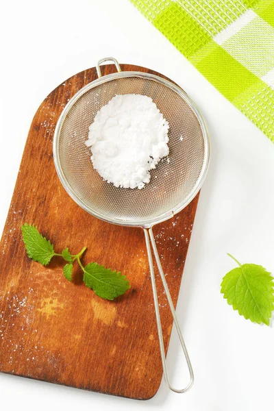 Powdered sugar in a sieve — Stock Photo, Image