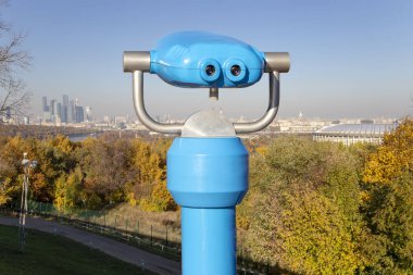 Turistik teleskop Görüntüleyici (dürbün) ve Sparrow Hills veya Vorobyovy Gory gözlem (görüntüleme) platformundan Merkezi Moskova görünümü--, Moskva nehrinin üzerinde dik bir banka 85 m veya deniz seviyesinden 200 m. Moscow, Rusya Federasyonu  