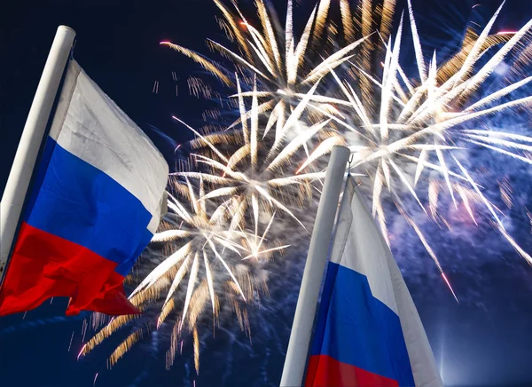 Gökyüzünde patlayan renkli havai fişekler ve rüzgarda gökyüzüne doğru sallanan Rusya bayrağı. Vatansever bir sembol olarak Rus dalgalı bayrağıüç renk  