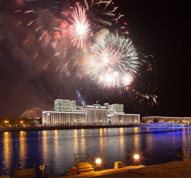 Main Building of the Ministry of Defence of the Russian Federation-- is the governing body of the Russian Armed Forces and celebratory colorful fireworks exploding in the skies. Moscow, Russia clipart