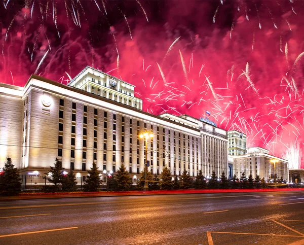 Main Building of the Ministry of Defence of the Russian Federation-- is the governing body of the Russian Armed Forces and celebratory colorful fireworks exploding in the skies. Moscow, Russia