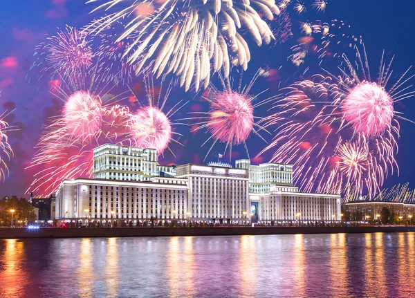 Main Building of the Ministry of Defence of the Russian Federation-- is the governing body of the Russian Armed Forces and celebratory colorful fireworks exploding in the skies. Moscow, Russia