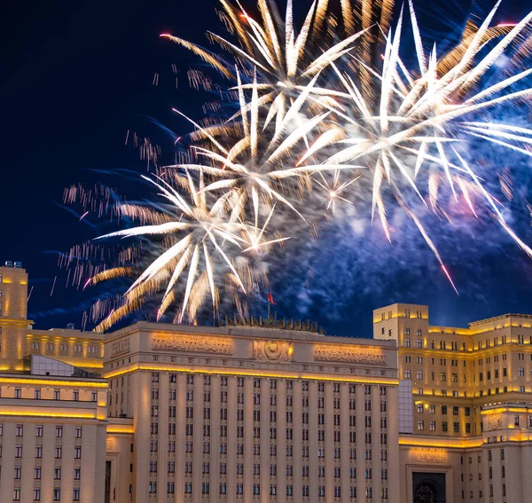 Main Building of the Ministry of Defence of the Russian Federation-- is the governing body of the Russian Armed Forces and celebratory colorful fireworks exploding in the skies. Moscow, Russia