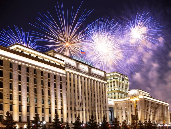 Main Building of the Ministry of Defence of the Russian Federation-- is the governing body of the Russian Armed Forces and celebratory colorful fireworks exploding in the skies. Moscow, Russia