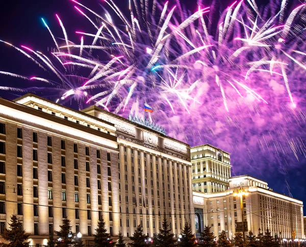 Main Building of the Ministry of Defence of the Russian Federation-- is the governing body of the Russian Armed Forces and celebratory colorful fireworks exploding in the skies. Moscow, Russia