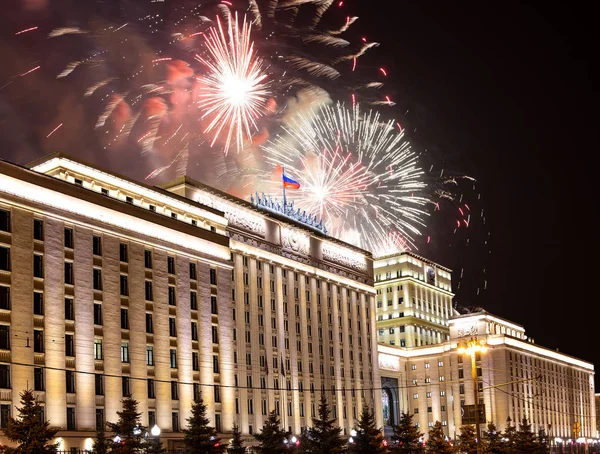 Main Building of the Ministry of Defence of the Russian Federation-- is the governing body of the Russian Armed Forces and celebratory colorful fireworks exploding in the skies. Moscow, Russia