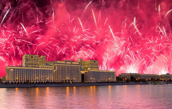 Main Building of the Ministry of Defence of the Russian Federation-- is the governing body of the Russian Armed Forces and celebratory colorful fireworks exploding in the skies. Moscow, Russia