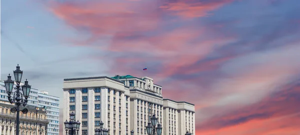 Building of The State Duma of the Federal Assembly of Russian Federation on a beautiful sky with cloud before sunset background, Moscow, Russia