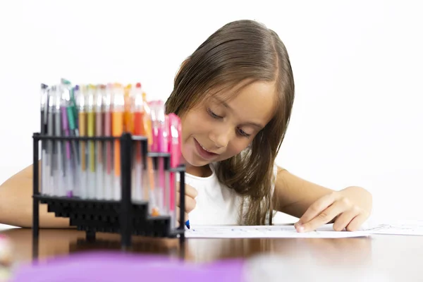 Niedliches Mädchen sitzt an seinem Schreibtisch malen — Stockfoto
