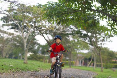 Bir bisiklet sürme neşeli küçük çocuk