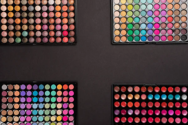 Makeup background of colorful eyeshadow palettes with copy space