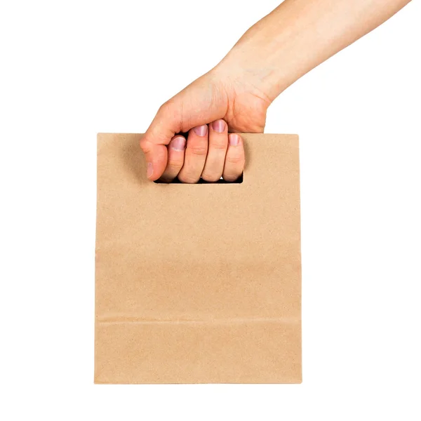 Hand holding kraft paper bag isolated on white background — Stock Photo, Image