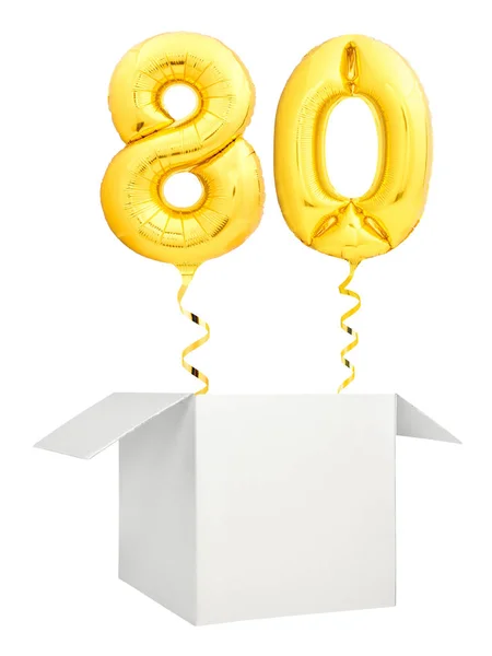 Ouro número vinte balão voando para fora da caixa branca em branco isolado no fundo branco — Fotografia de Stock