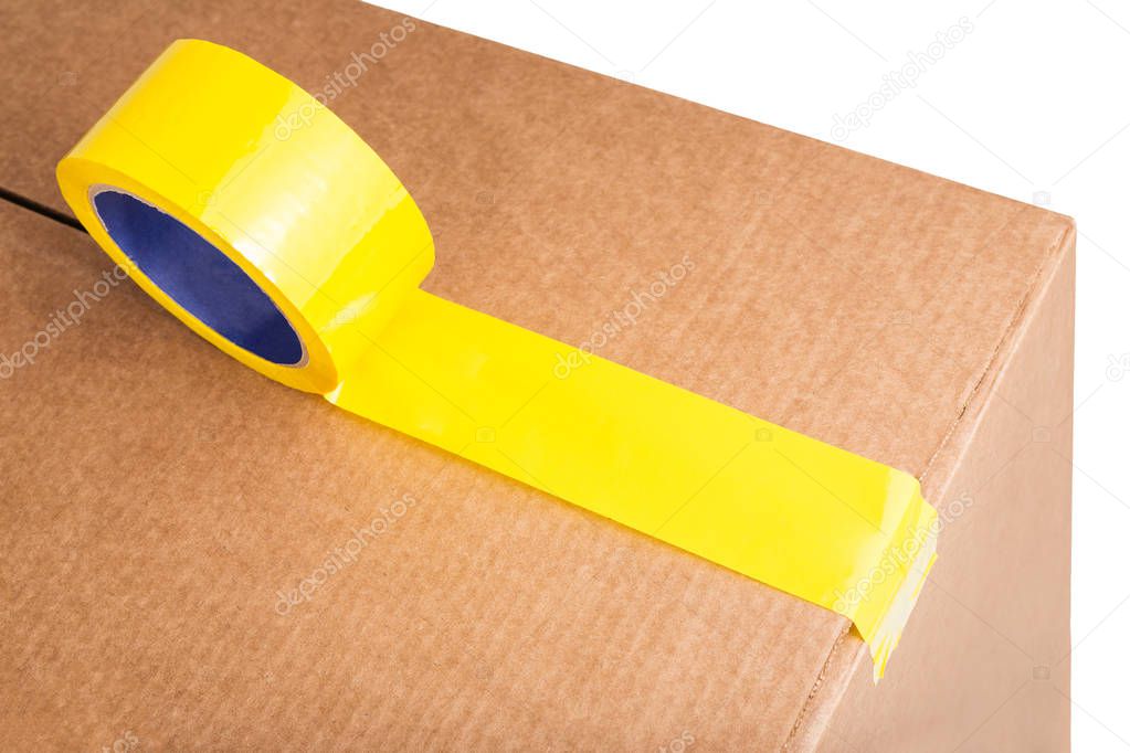 Cardboard box with yellow adhesive tape