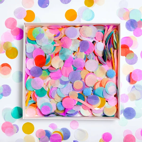 Boîte avec confettis sur fond coloré — Photo