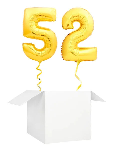 Golden number fifty two inflatable balloon with golden ribbon flying out of blank white box isolated on white background — Stock Photo, Image