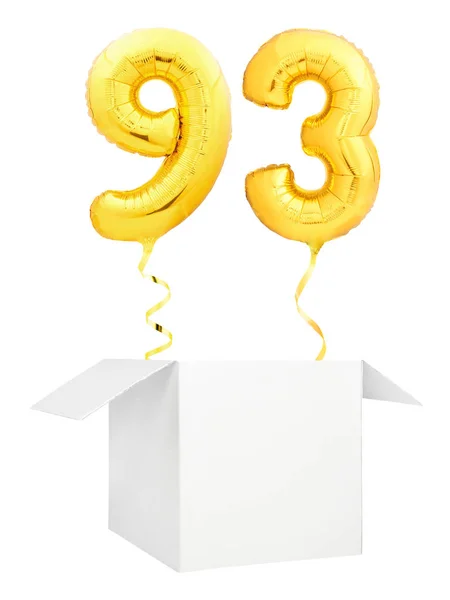 Golden number ninety three inflatable balloon with golden ribbon flying out of blank white box isolated on white background — Stock Photo, Image