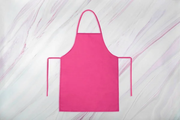 Pink apron on marble background with natural pattern — Stock Photo, Image